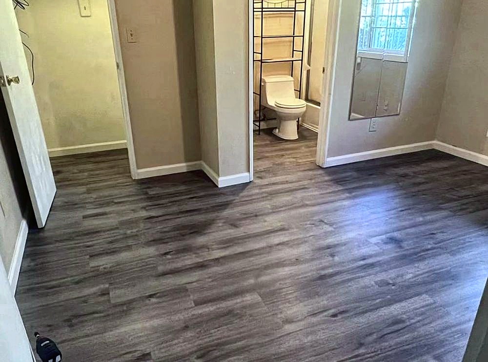 New wood-look vinyl plank floor running through a hallway
